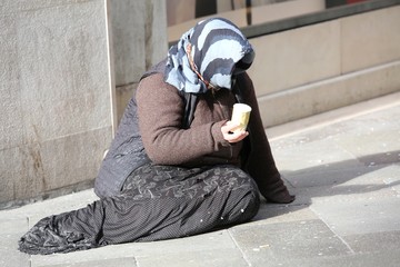 old gypsy asks for charity