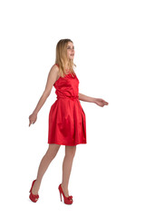 The young attractive woman in an evening dress goes on a party, isolated