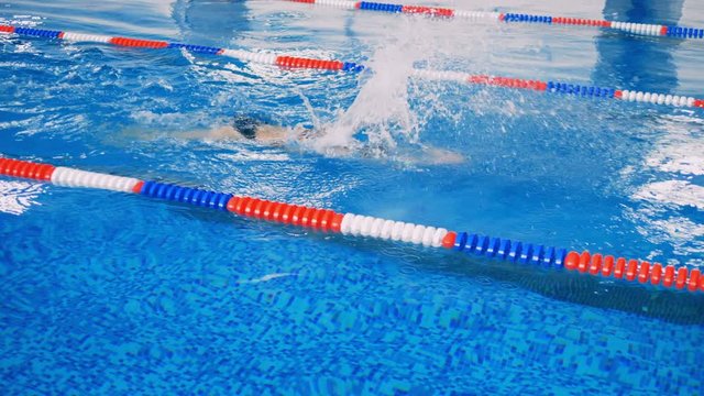 An athlete does training in a pool.