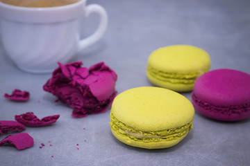 Macaroni cakes on a gray concrete background.