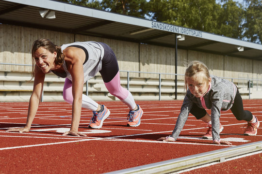 Mother and daughter on running track