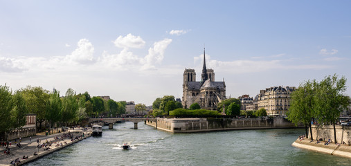 Panoramic view of ile de la Cité and the Seine with Notre Dame de Paris cathedral in the distance during sunset