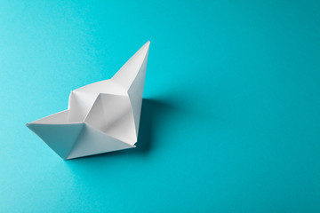 boat paper origami on the blue background