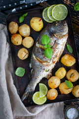 Baked dorado with Provencal herbs and potatoes.