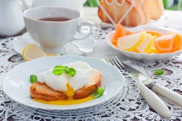 Cut egg-poached on a toast on a white plate, horizontal