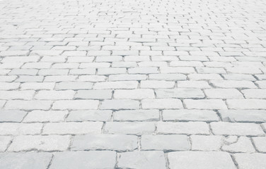 Whitewashed cobblestone pavement background for text or image