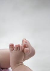 baby feet on white blanket. copy space. selective focus