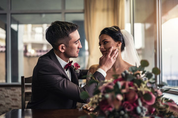 Cute wedding cuople relaxing in resturant