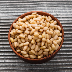 peeled pine nuts on a rustic background