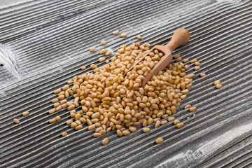 peeled pine nuts on a rustic background