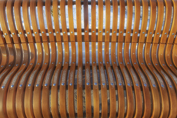 a wooden bench in a winter park on a sunny day