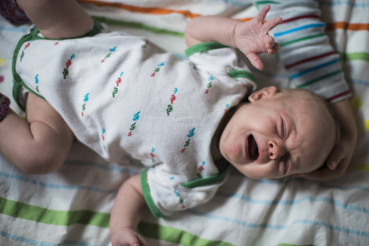 Crying baby in cot
