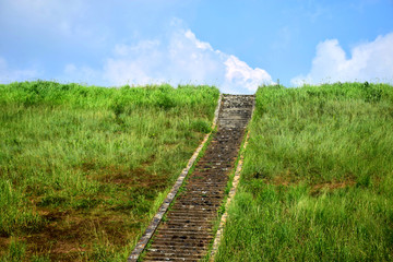 Fototapeta na wymiar Stairs up the hill on the ridge of the reservoir