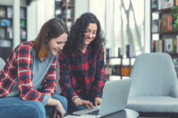 Happy students with laptop