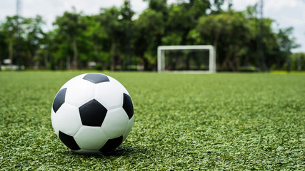 Fototapeta na wymiar football field ball on green grass , soccer field background texture