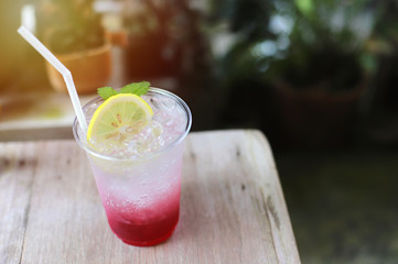 Summer tasty drink, fresh lemon iced with soda and berry in the cafe, summer concept