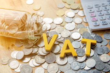 Vat Concept.Word vat put on coins and calculator on table.