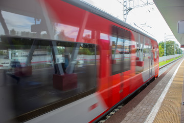 Train with passengers moving by rail.