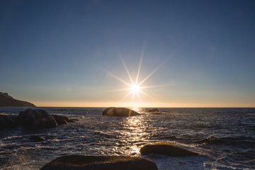 Sunset over the water with rocks