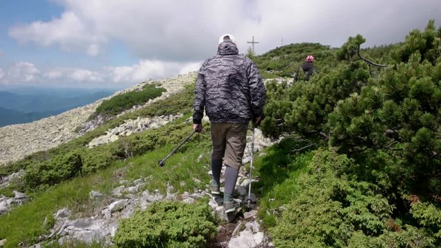 Young people with gogs Fox terrier hiking in mountains, travel, fitness or adventure concept outdoors in nature filmed with steadicam