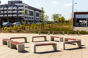 New wooden benches on the street in the city district. A good place to relax.