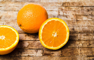 Orange slices on rustic wooden background