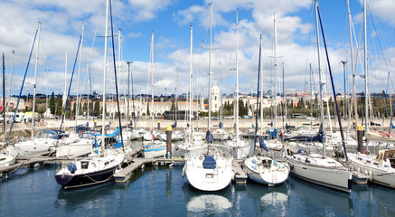 Panorama of the port with white sports yacht and an ancient town in the background 