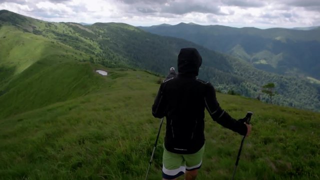 Young people with gogs Fox terrier hiking in mountains, travel, fitness or adventure concept outdoors in nature filmed with steadicam