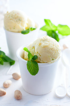 Homemade pistachio ice cream in white cups, selective focus