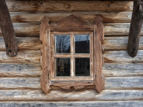 Window of the old rural house in a wooden frame