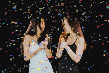 Happy young asian girls with confetti in a party.Celebration party concept