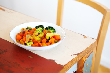 white plate with mixed vegetables on wooden table