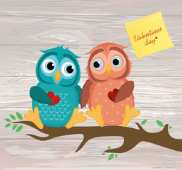 A pair of cute owlet sitting on a branch. Yellow sheet of paper 