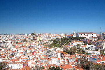 Fototapeta na wymiar Ancient white houses with red roofs of the old town of Lisbon, Portugal