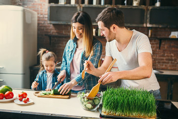 Family cook together in the kitchen.