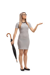 Young woman with an umbrella checking to see if it is raining