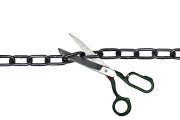 Old scissors cutting metal chain, isolated on white background