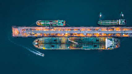Aerial top view of oil tanker ship at the port, Aerial view oil terminal is industrial facility for...