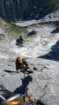 mountain guide on a hard granite climb to a high alpine peak in the Swiss Alps