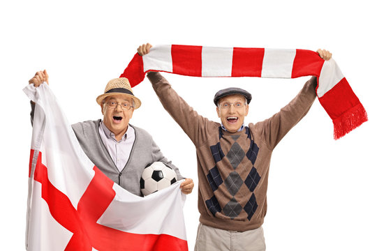 Overjoyed elderly soccer fans with an English flag and a scarf