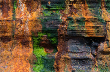 Close up detail of Colourful cliff face rock texture on the west coast of Ireland