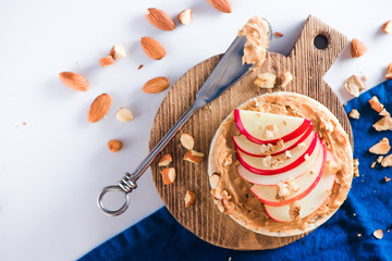 Apple crisp bread toast with apple slices, peanut butter, almonds and walnuts. Healthy breakfast...