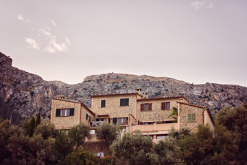 Fototapeta na wymiar Traditional building on Mallorca at sunrise and mountains in the background