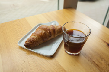 Morning cup of coffee and croissant.