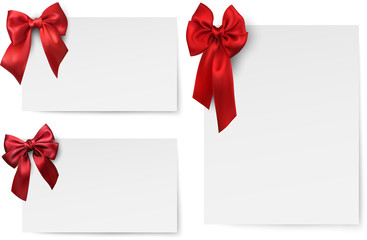 White paper cards with red satin bow.