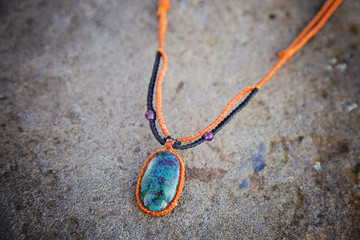 Natural gemstone necklace on stone background