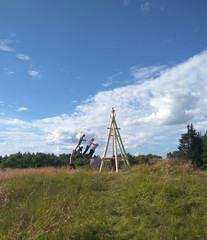 children swinging on the huge village swings