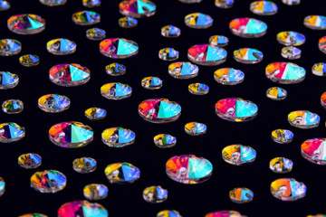 Precious stones crystals in the shape a rivoli on a black background.