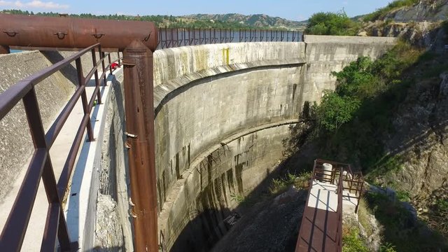 Dam wall with blue water of the reservoir