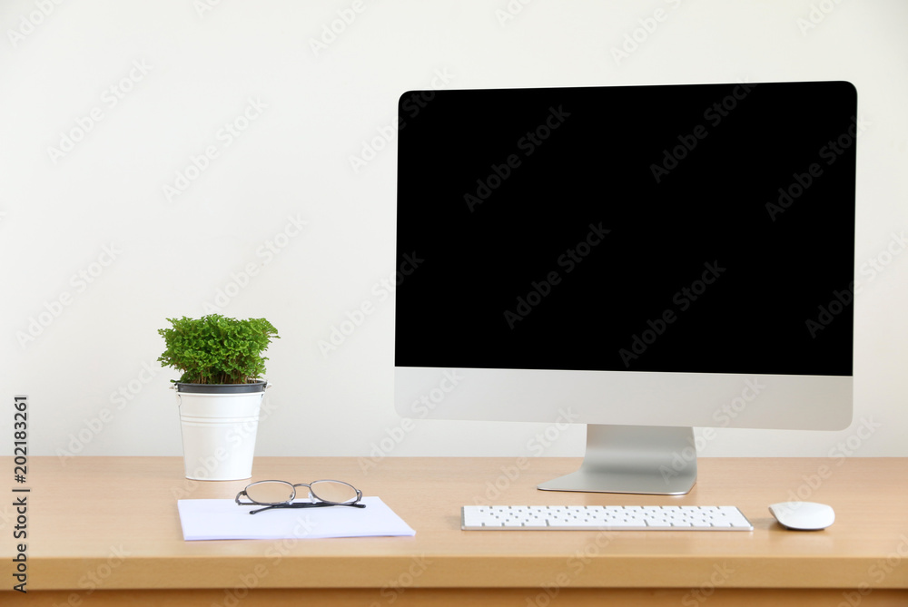 Poster mock up front view blank screen computer all in one with mouse, keyboard,pencils and tree vase in mo